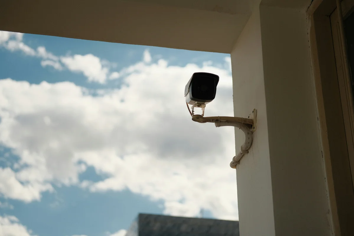 Homeowner installing security camera for better privacy Homeowner installing security camera for better privacy