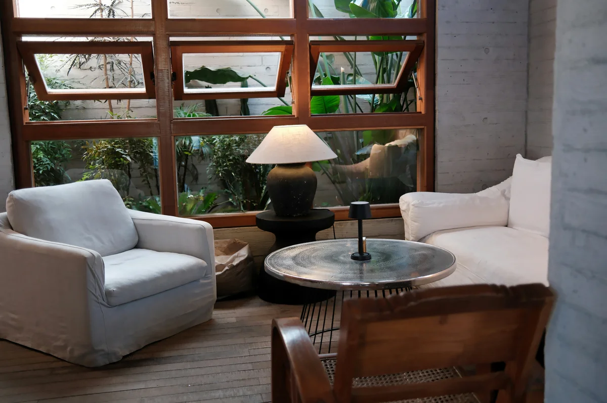 A cozy reading nook featuring a comfortable chair and plants A cozy reading nook featuring a comfortable chair and plants