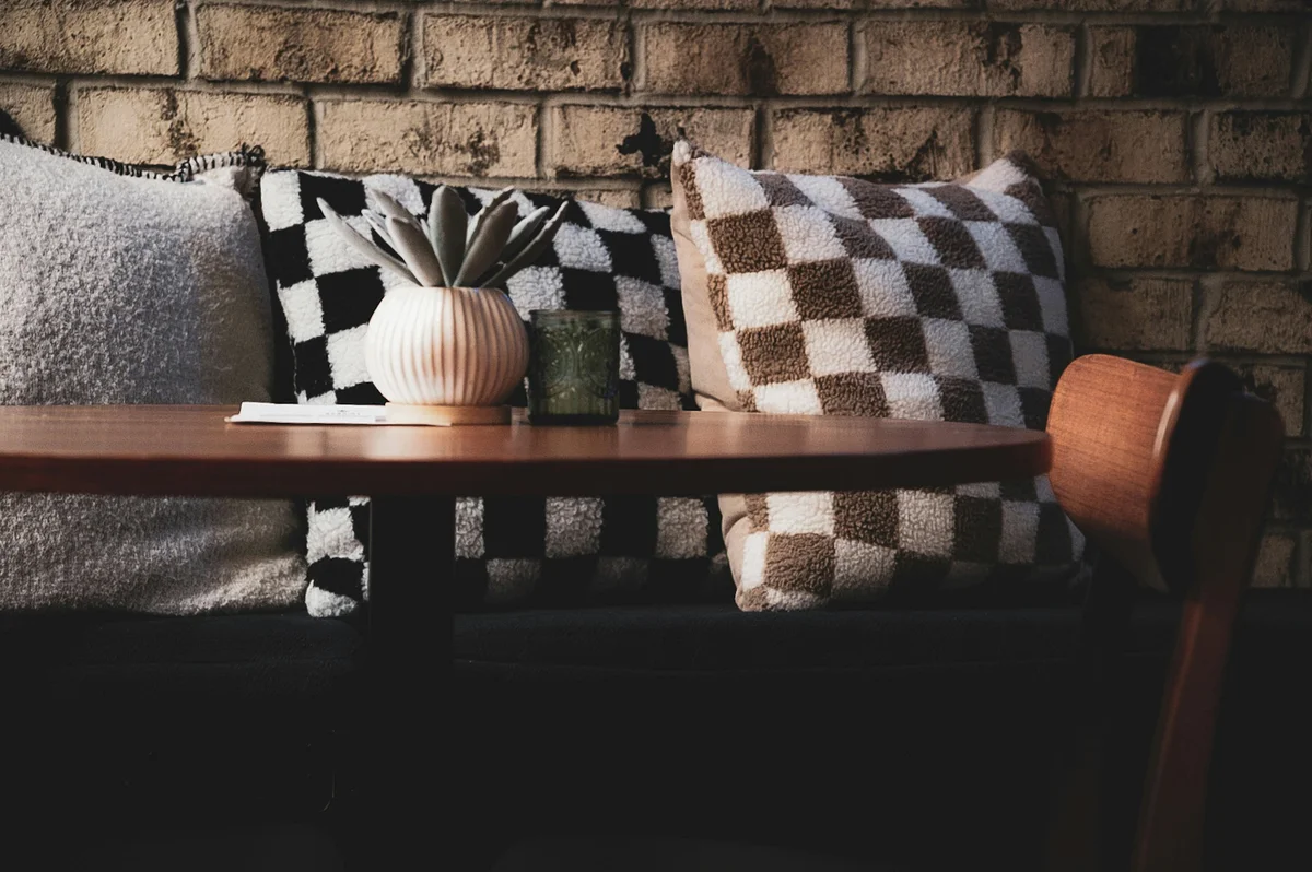 Checkerboard patterned pillows on a stylish sofa Checkerboard patterned pillows on a stylish sofa