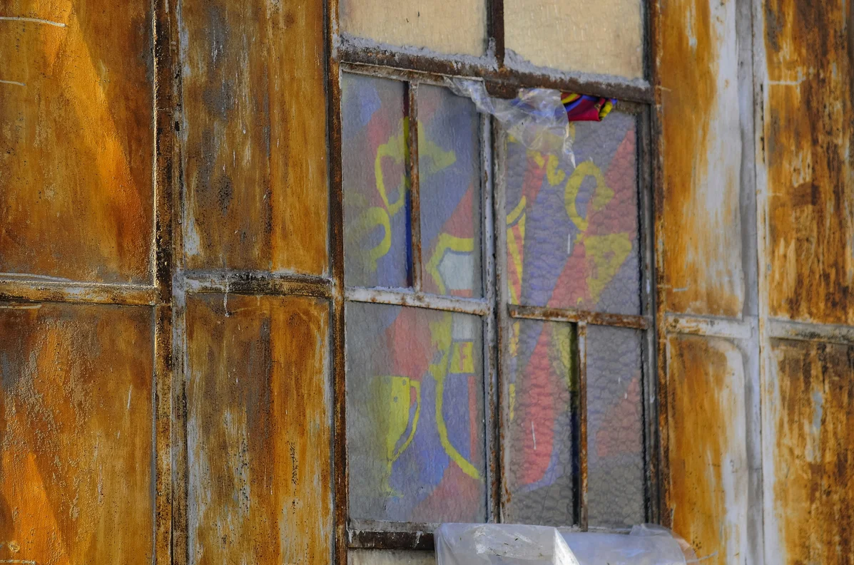Person applying tissue paper to a window for DIY treatments Person applying tissue paper to a window for DIY treatments