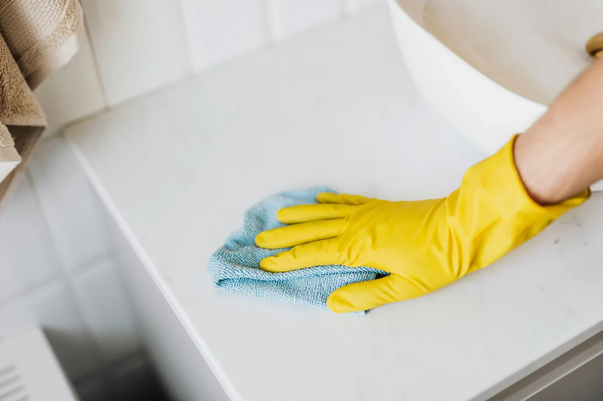 Person using a microfiber duster at home Person using a microfiber duster at home