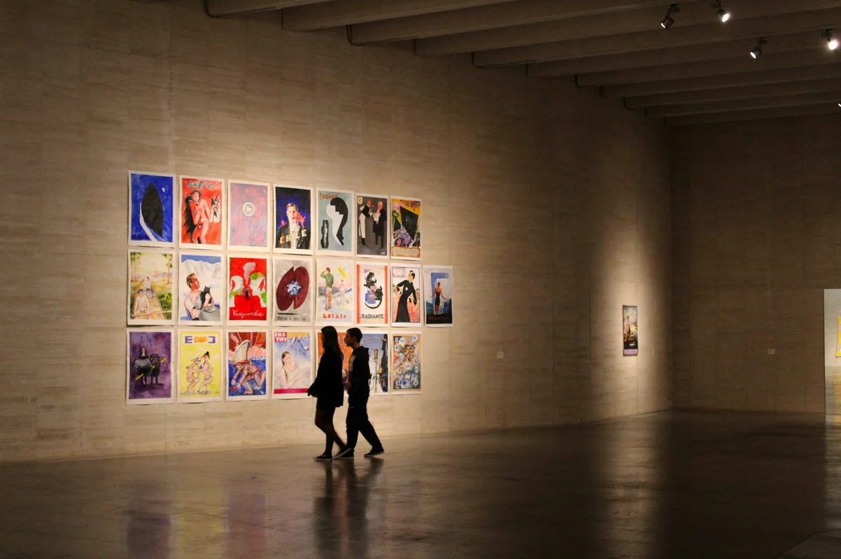 A large wall filled with a well-arranged gallery of art pieces A large wall filled with a well-arranged gallery of art pieces