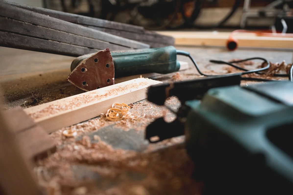 Woodworking tools used to create a guitar wall hook, including saw and drill Woodworking tools used to create a guitar wall hook, including saw and drill