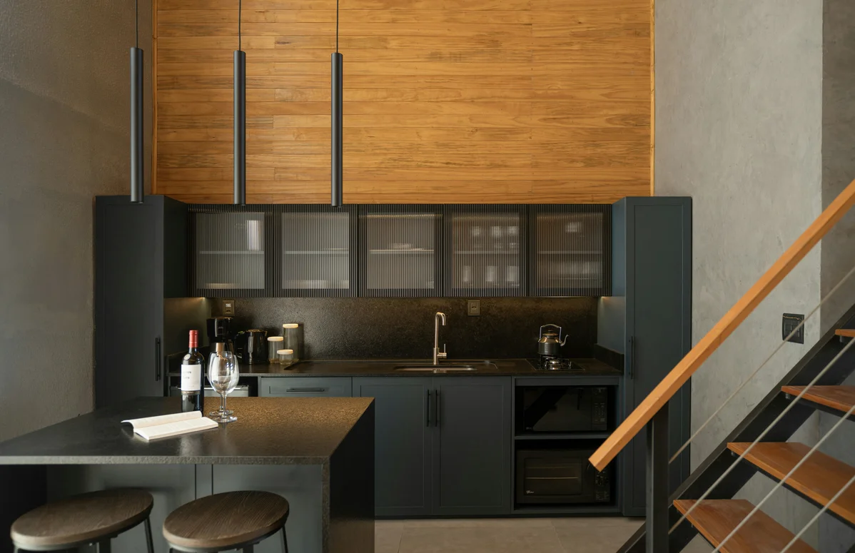 Elegant home bar space with bookshelves and seating Elegant home bar space with bookshelves and seating