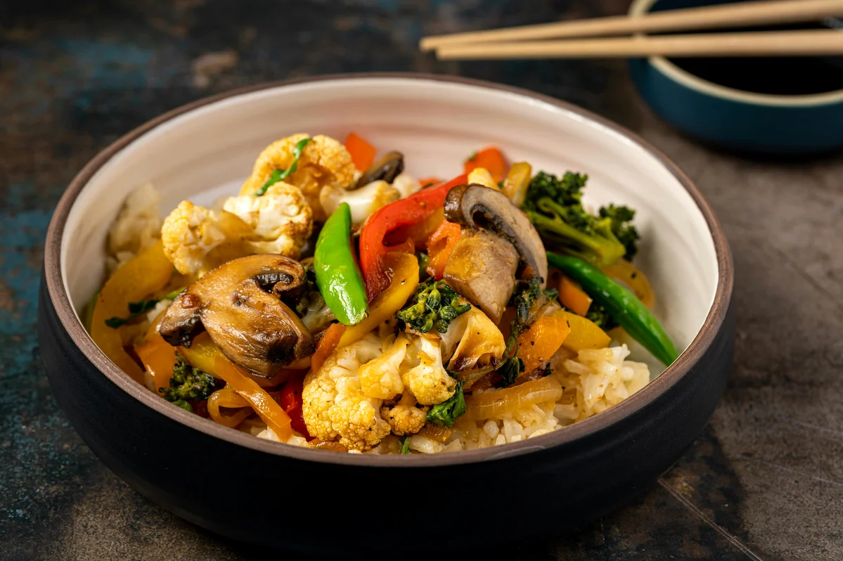 Bowl of brown rice mixed with colorful vegetables Bowl of brown rice mixed with colorful vegetables