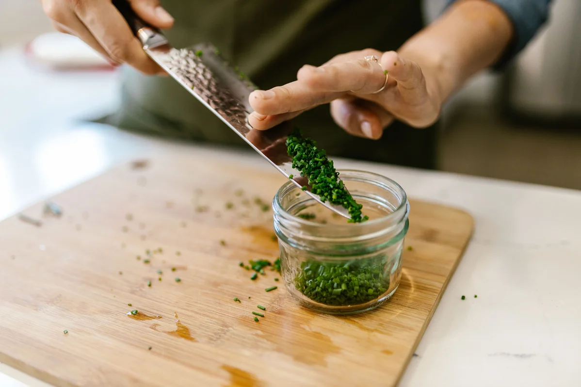 Harvesting chives in a home garden Harvesting chives in a home garden