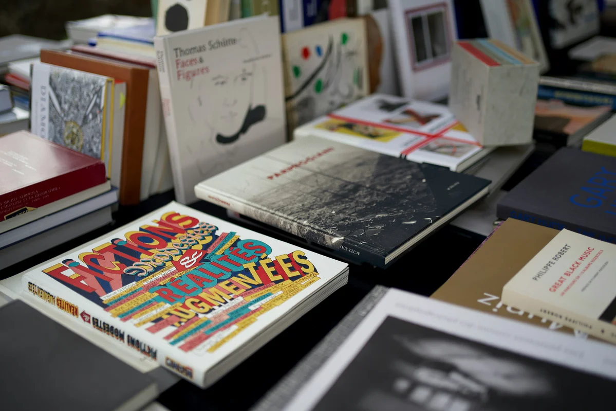 Books displayed creatively on a coffee table and windowsill Books displayed creatively on a coffee table and windowsill