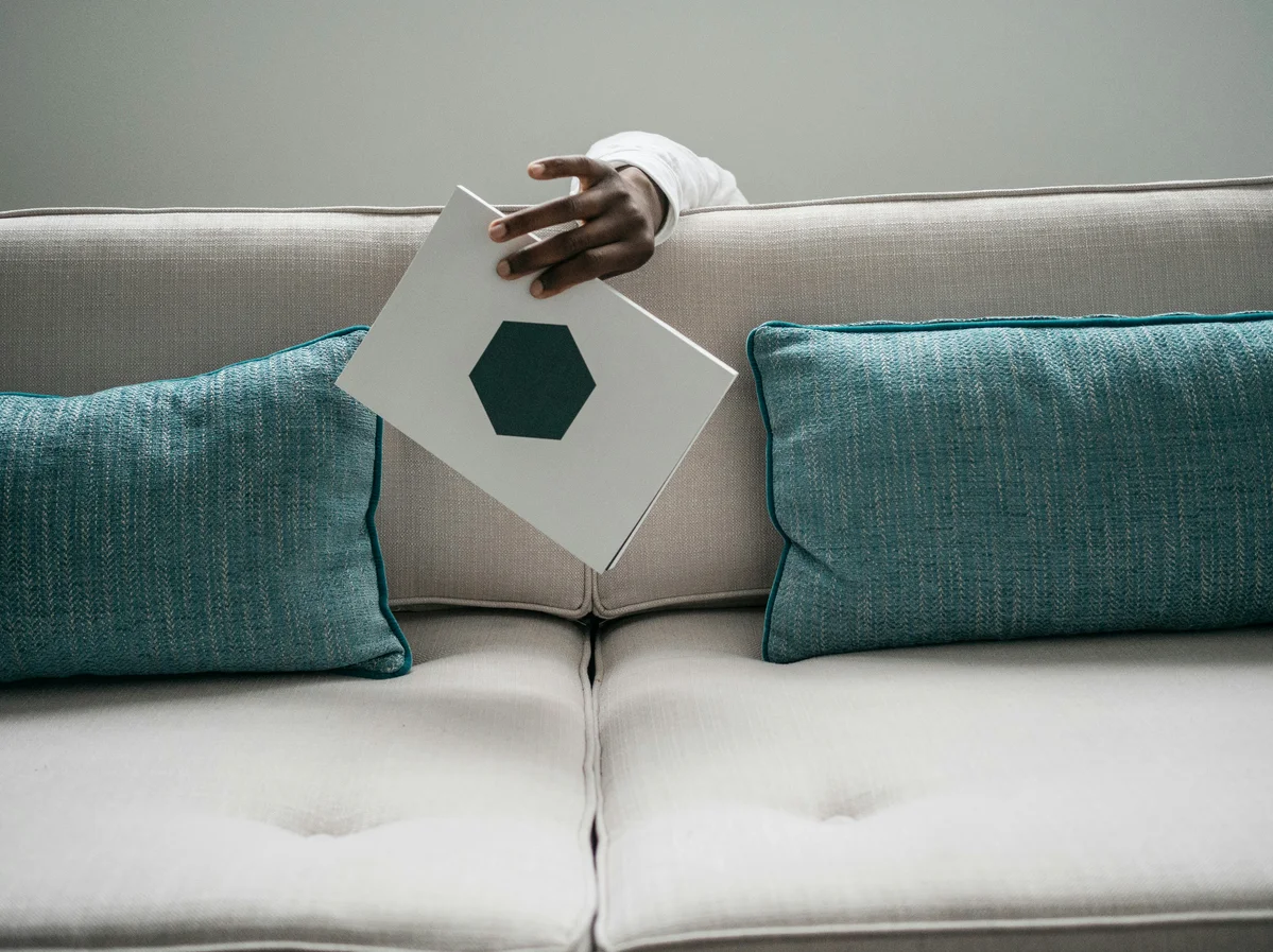 Using a vacuum cleaner on a white sofa to maintain cleanliness Using a vacuum cleaner on a white sofa to maintain cleanliness