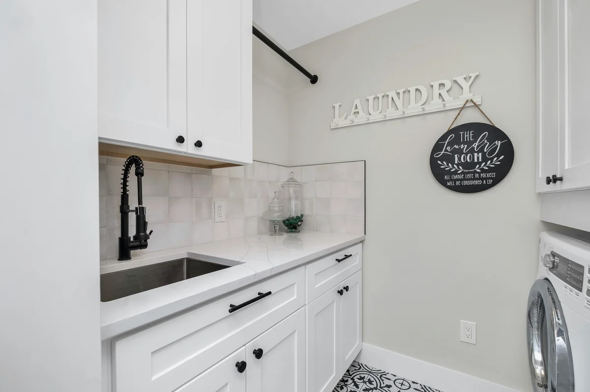 Organized laundry room with various storage containers Organized laundry room with various storage containers