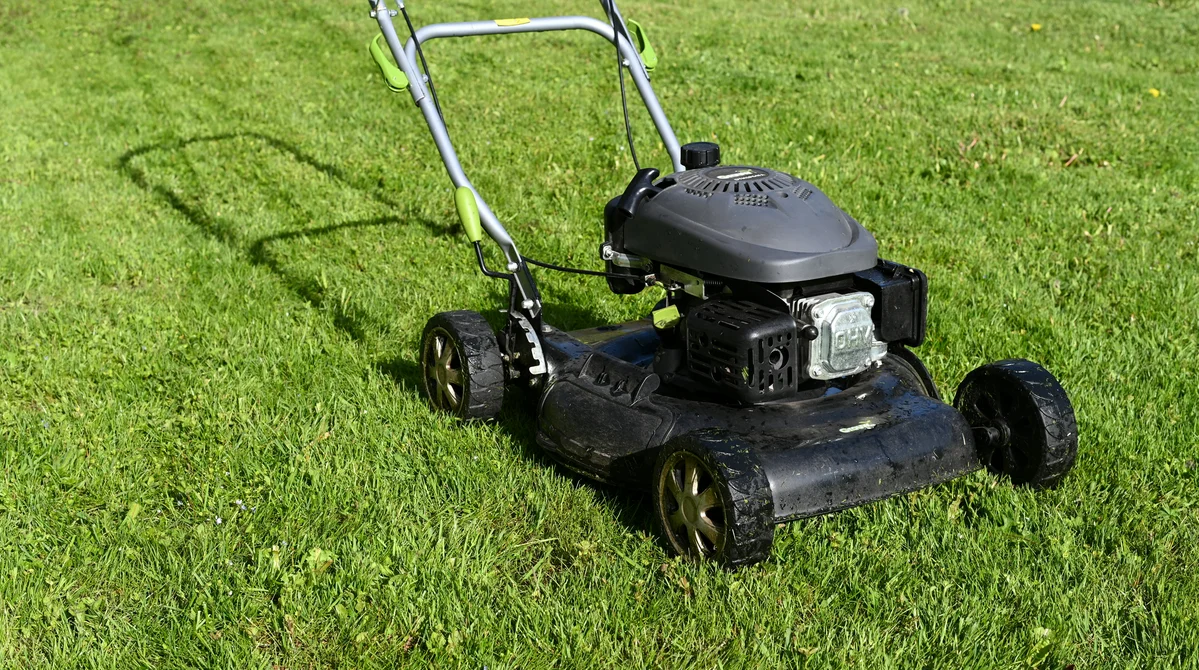 A close-up of a dull lawn mower blade showing wear and tear A close-up of a dull lawn mower blade showing wear and tear