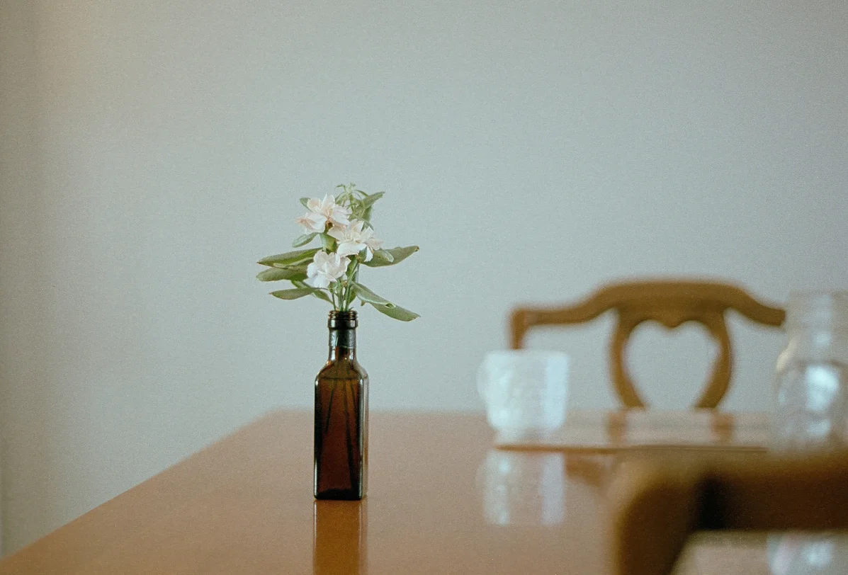 Bottle of almond oil placed on a wooden table Bottle of almond oil placed on a wooden table