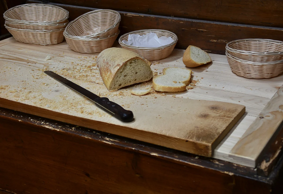 Old bread pans repurposed as rustic organizers in a home setting Old bread pans repurposed as rustic organizers in a home setting
