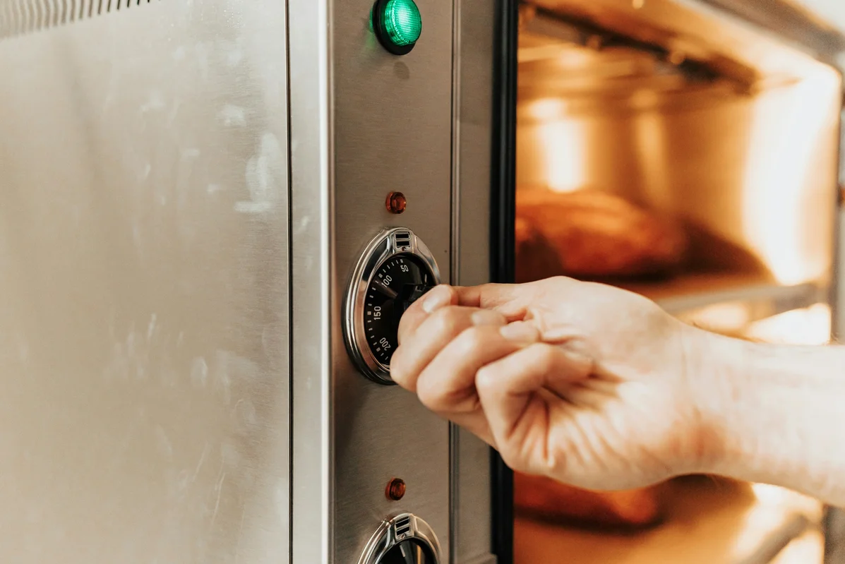 A person setting Sabbath mode on an oven A person setting Sabbath mode on an oven