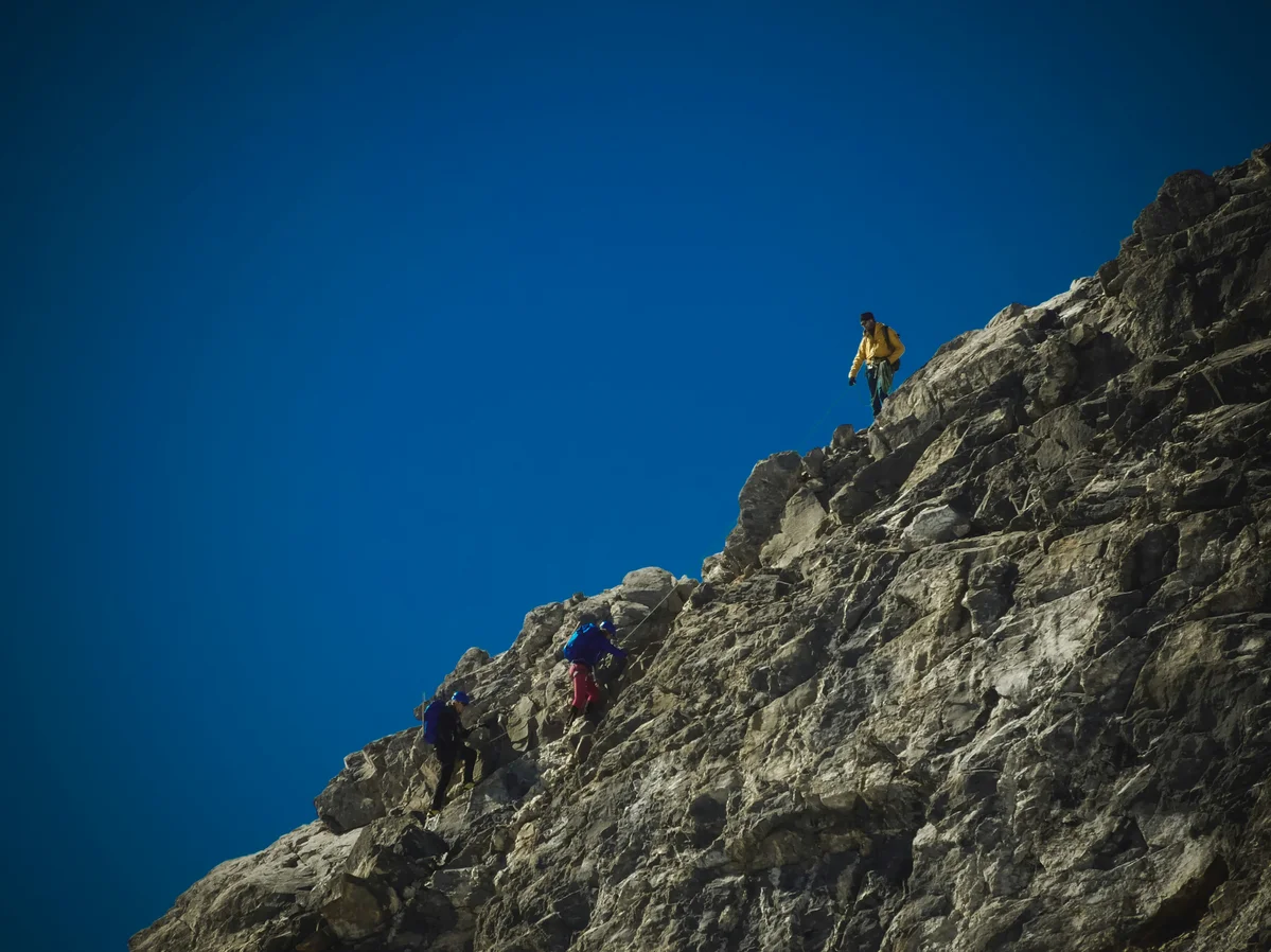 Children climbing a mountain, symbolizing overcoming challenges and personal growth Children climbing a mountain, symbolizing overcoming challenges and personal growth