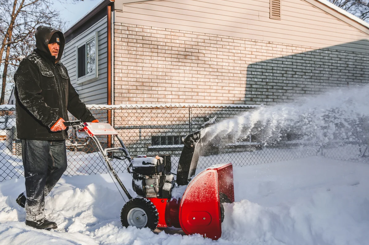 An oil change being performed on a snowblower An oil change being performed on a snowblower