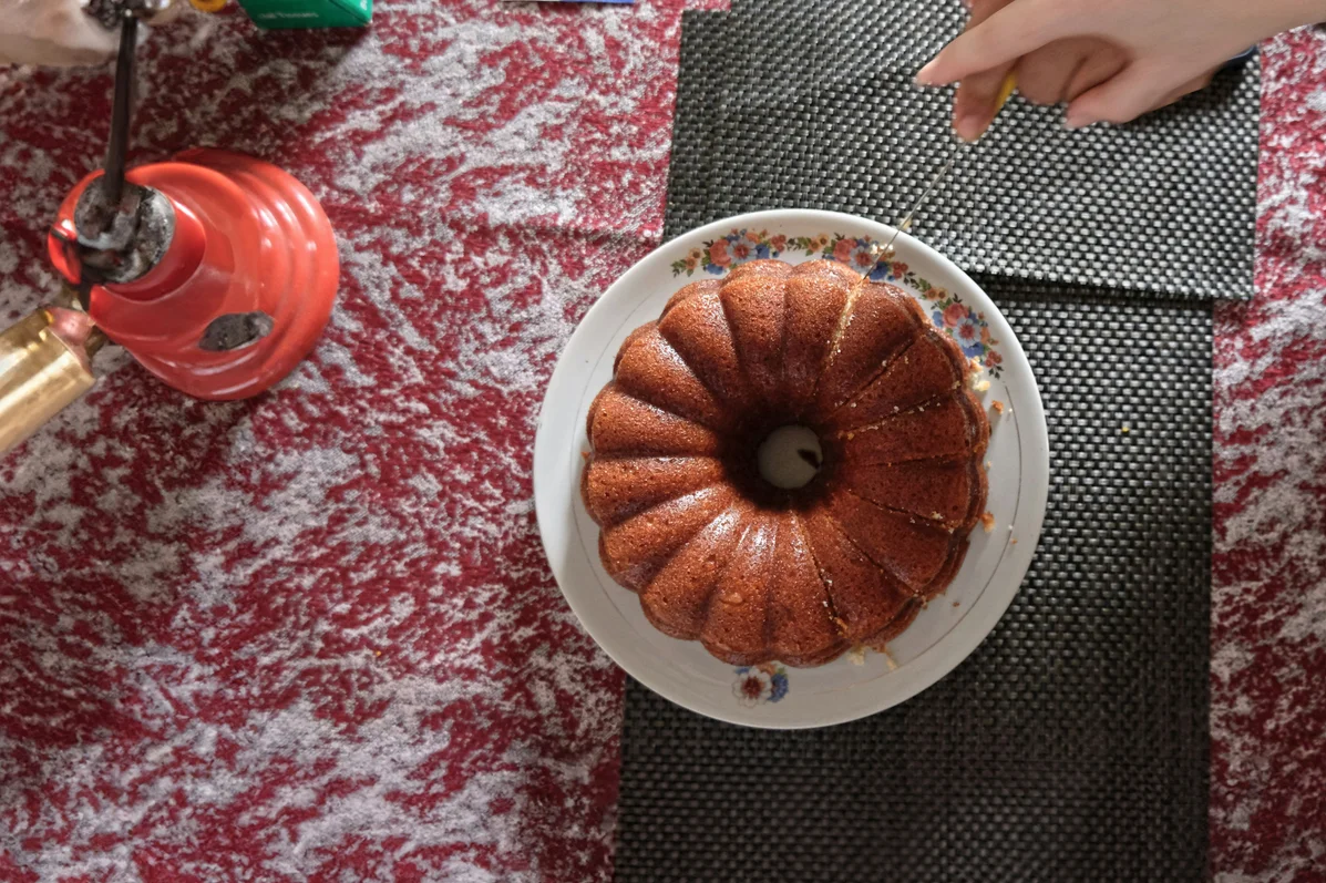 A person cleaning a thrifted Bundt pan in preparation for decoration A person cleaning a thrifted Bundt pan in preparation for decoration