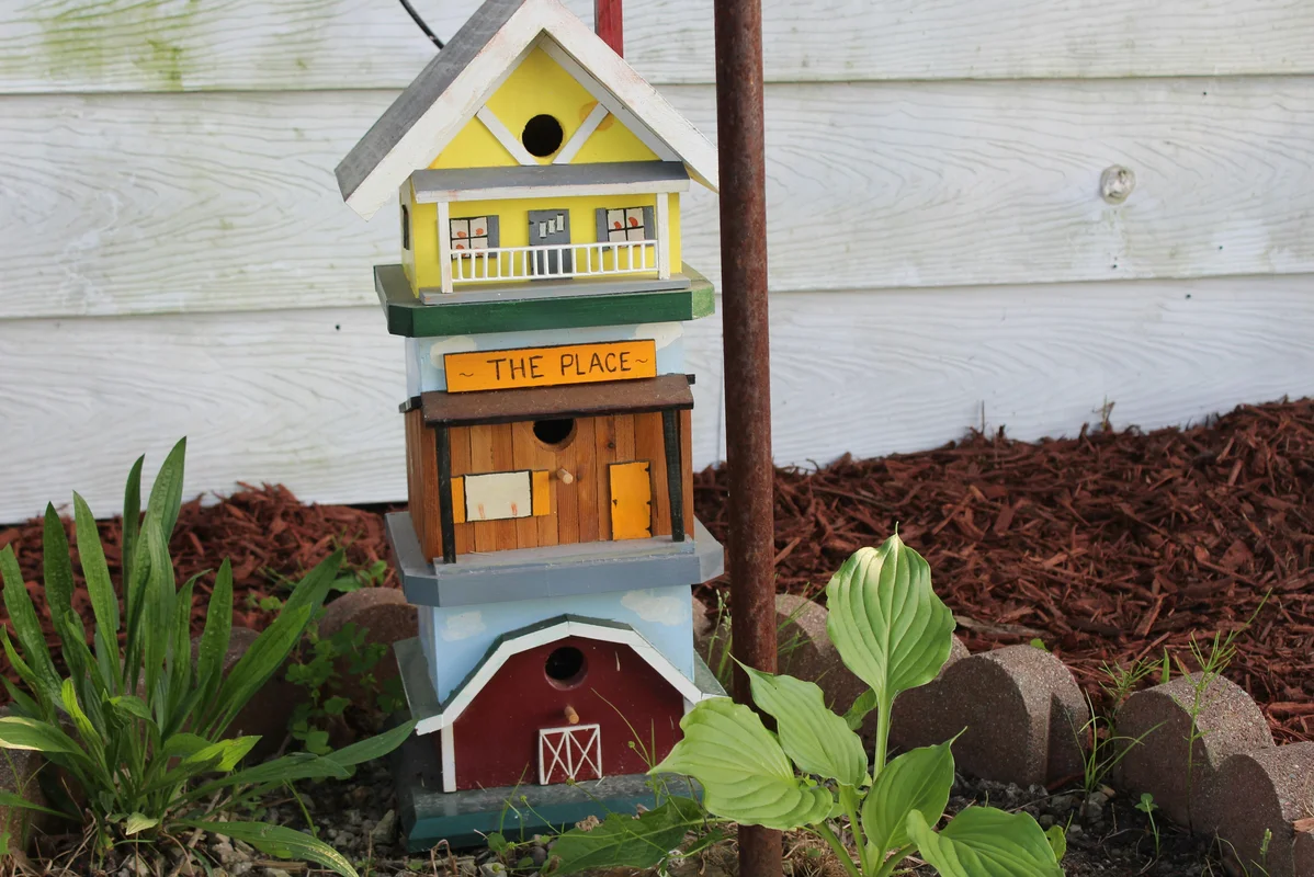 Customized upcycled birdhouse with decorative elements Customized upcycled birdhouse with decorative elements