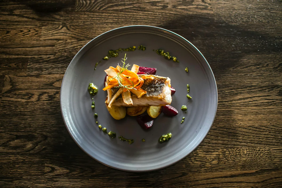 A gourmet dish beautifully plated with garnishes A gourmet dish beautifully plated with garnishes