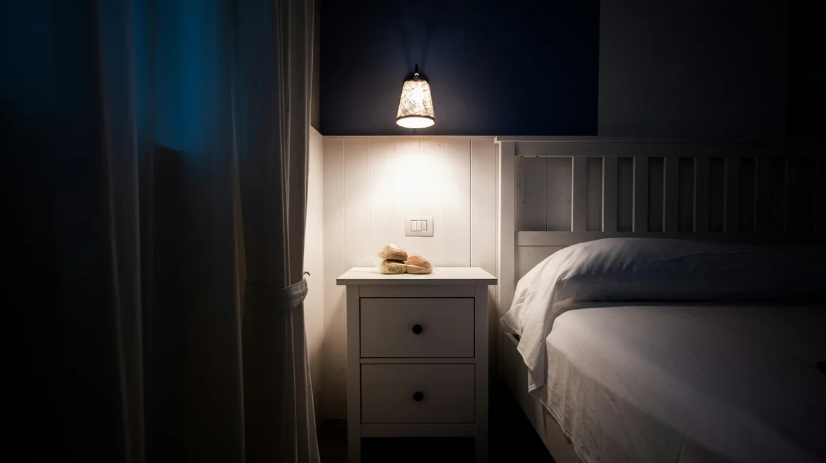 a sleep tracking device on a nightstand, illustrating how much sleep is beneficial a sleep tracking device on a nightstand, illustrating how much sleep is beneficial
